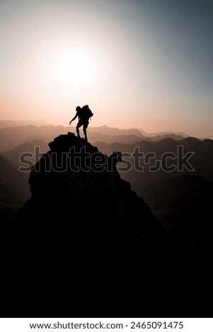 Similar – Image, Stock Photo Two mountaineers climb a summit with a summit cross in heavy snowfall. There is no room at the summit cross.