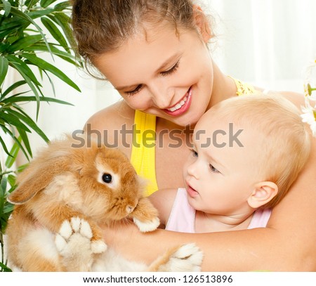 young mother,baby and their pet rabbit