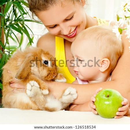 young mother,baby and their pet rabbit