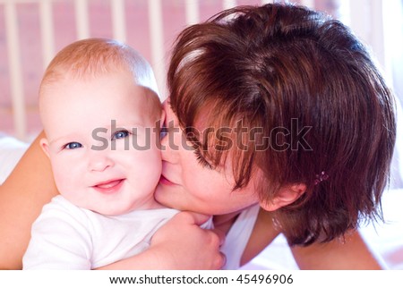 A mother kissing her cute baby