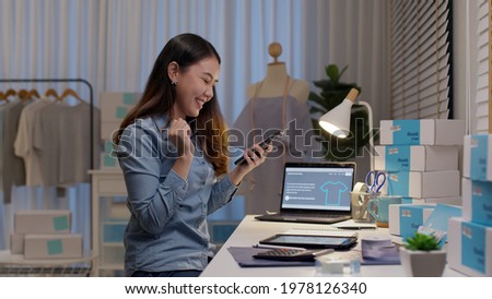 Young attractive beautiful female entrepreneur fund borrower crazy joyful ecstatic face gesture hand yes feeling amazed in peer to peer P2P lending finance or crowdfunding network microfinance approve 商業照片 © 
