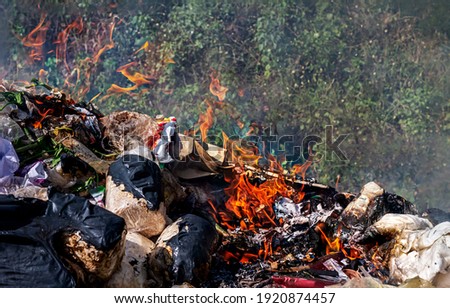 fire burn garbage waste plastic, smoke polluted of waste plastic incineration, garbage waste disposal with burnt incinerate, fire flame garbage burning and smoke air pollution