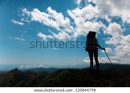 Silhouettes of tourists on a background of blue sky with clouds