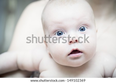 Portrait of a a small child with surprise on his face