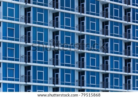 The modern architectural background. The building\'s facade with balconies made ??of glass