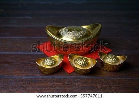 Chinese Gold Ingots On A Rustic Wooden Background Text Means Lucky Wealth And Chinese Gold Ingots On A Rustic Wooden Background Text Means Lucky Wealth And