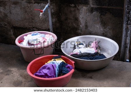 Similar – Image, Stock Photo Washing up bowl filled with the washed outdoor dishes, plates, cups and cutlery put on grass