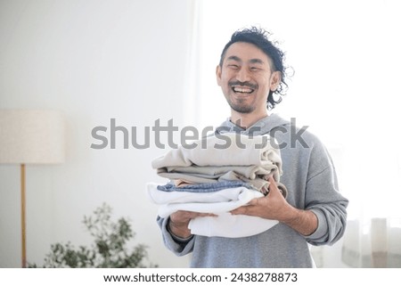 Similar – Image, Stock Photo Getting laundry out of the washing machine