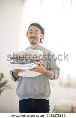 Similar – Image, Stock Photo Getting laundry out of the washing machine