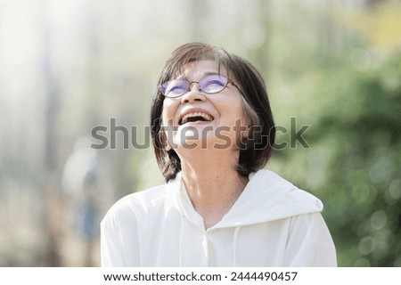 Similar – Image, Stock Photo Close up backlight portrait of a young, freckled woman with wind-blown hair in front of a bush