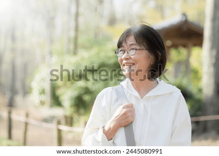 Similar – Image, Stock Photo Close up backlight portrait of a young, freckled woman with wind-blown hair in front of a bush