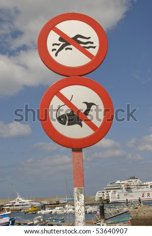 No Fishing and No Swimming signs on blue sky