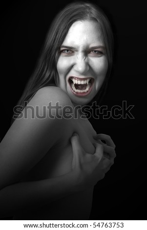 Portrait of a female vampire on black background.
