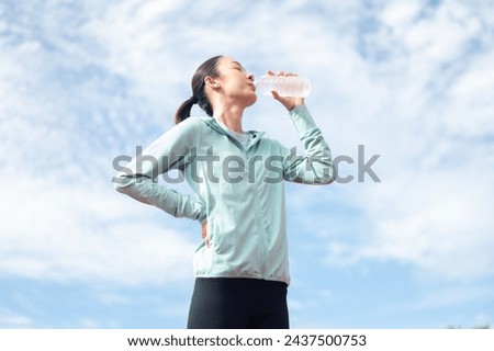 Similar – Image, Stock Photo Slim sportswoman drinking water in park