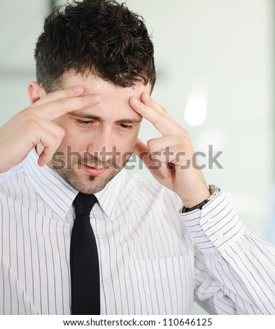 Stress and concern, businessman holding his head at office
