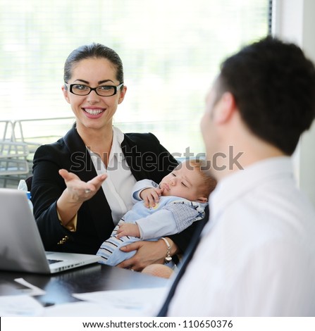 Business people with newborn infant baby child in office