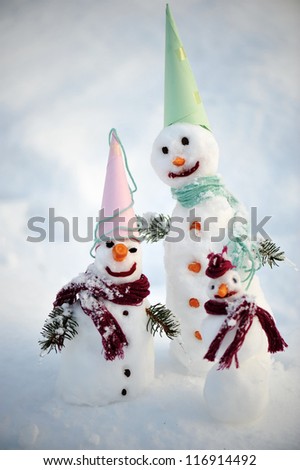 Happy family of snow people snowman
