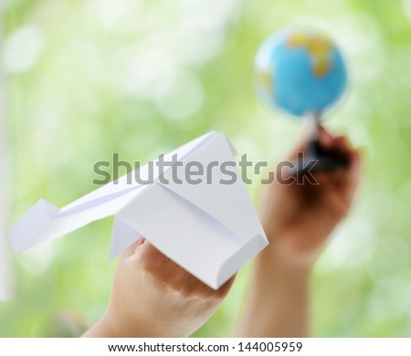 Paper plane traveling to globe world