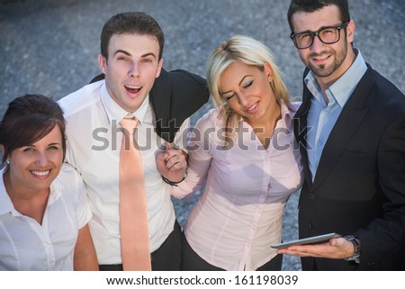 Group of happy business people posing on a street