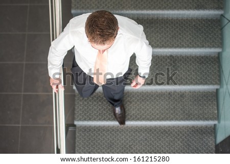 Sleek corporate man ascending stairs