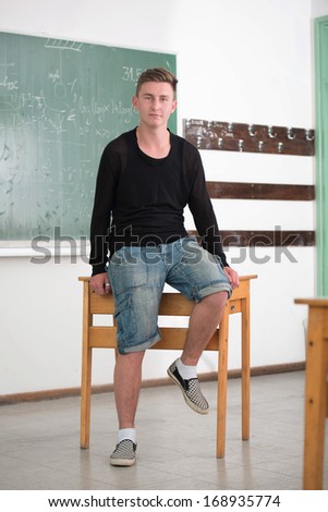 Casually dressed student sitting in classroom