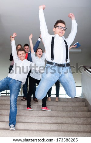 Students jumping on steps in school
