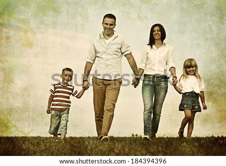 Retro photography of a family on green summer grass meadow having happy life