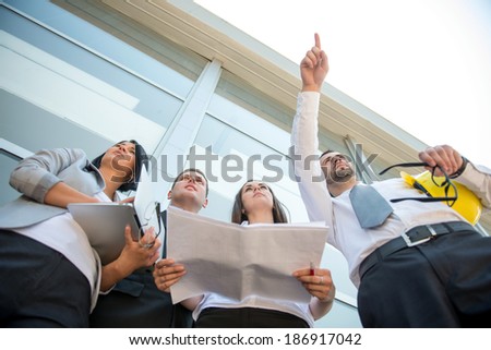 Young business man pointing finger on a construction site