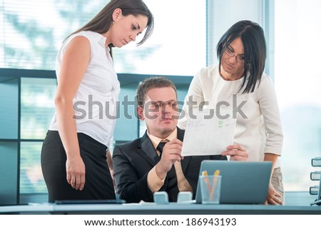Three young people working in business environment
