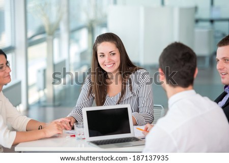 Happy business woman posing during a work meeting in modern office