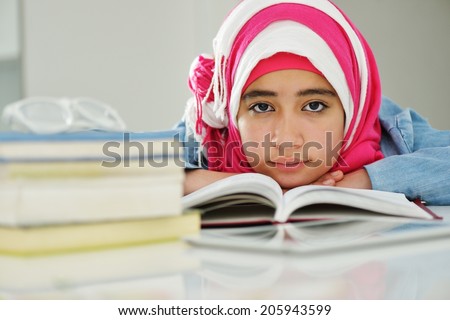 Beautiful Arabic Muslim girl reading on college