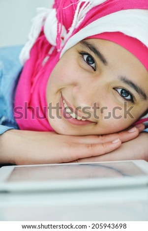 Portrait of beautiful Arabic Muslim girl using tablet