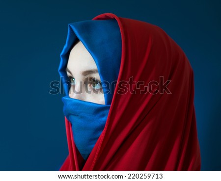 Beautiful Middle eastern girl with a veil on red and blue