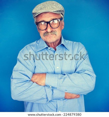 Portrait of a smiling and confident senior good looking business man with hat