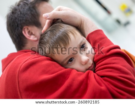 Dad hugging his little baby boy