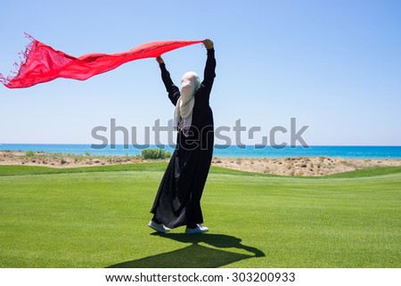 Happy Arabic Muslim girl in beautiful nature