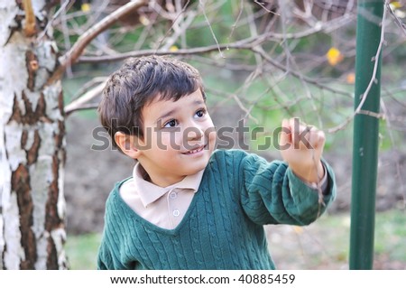 Happy positive cute kid outdoor, fall period