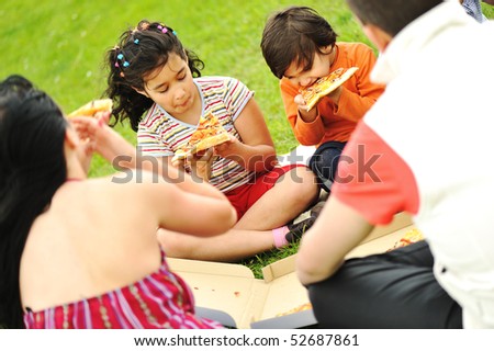 Happy people outdoor, family eating pizza