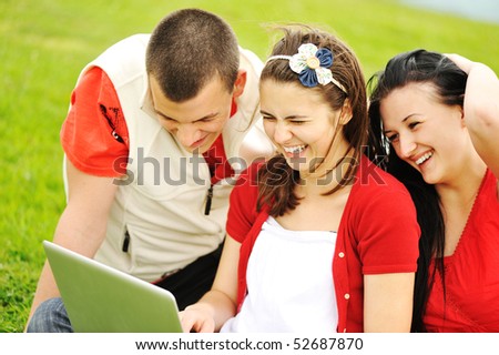 Happy people outdoor, happy scene, friends on laptop