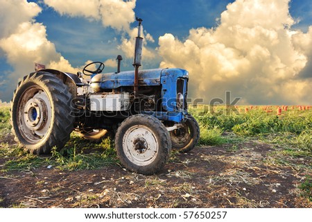 Very old tractor in field, different parts - no trademark at all