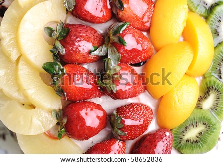 Beautiful yummy fruit cake: strawberry, kiwi, mango, bananas and chocolate