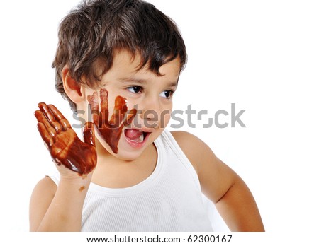 Cute messy kid isolated on white eating chocolate - stock photo