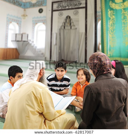 Muslim people teaching and learning inside the mosque, man, woman and children together reading Koran