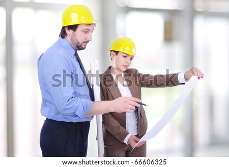 Man and woman architects on a building construction site