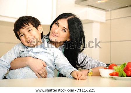 Happy mother and little son in the kitchen, happy time and togetherness