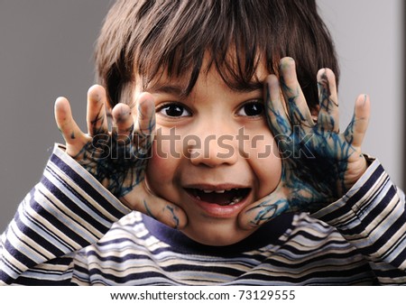 Child with messy hands, green color