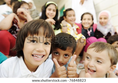 Large group, crowd, lot of happy children of different ages, summer outdoor sitting