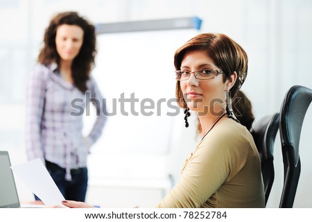 Business women holding a conference writing on an a board in an office