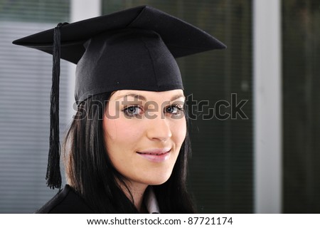 Student girl in an academic gown, graduating and diploma