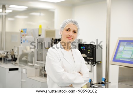 Working woman at automated production line in modern factory